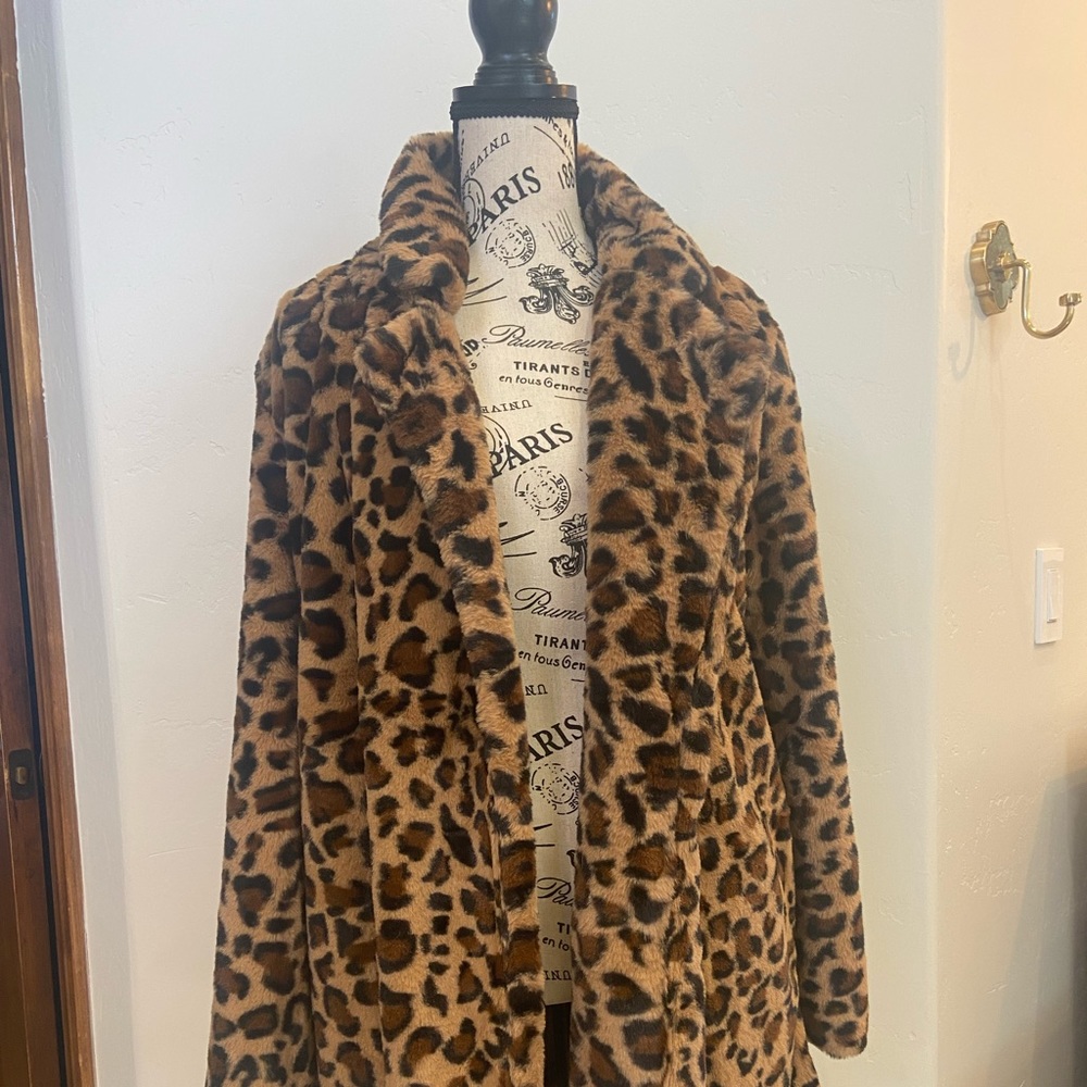 Faux fur leopard print jacket. Size med. Fluffy with pockets. Mid thigh length